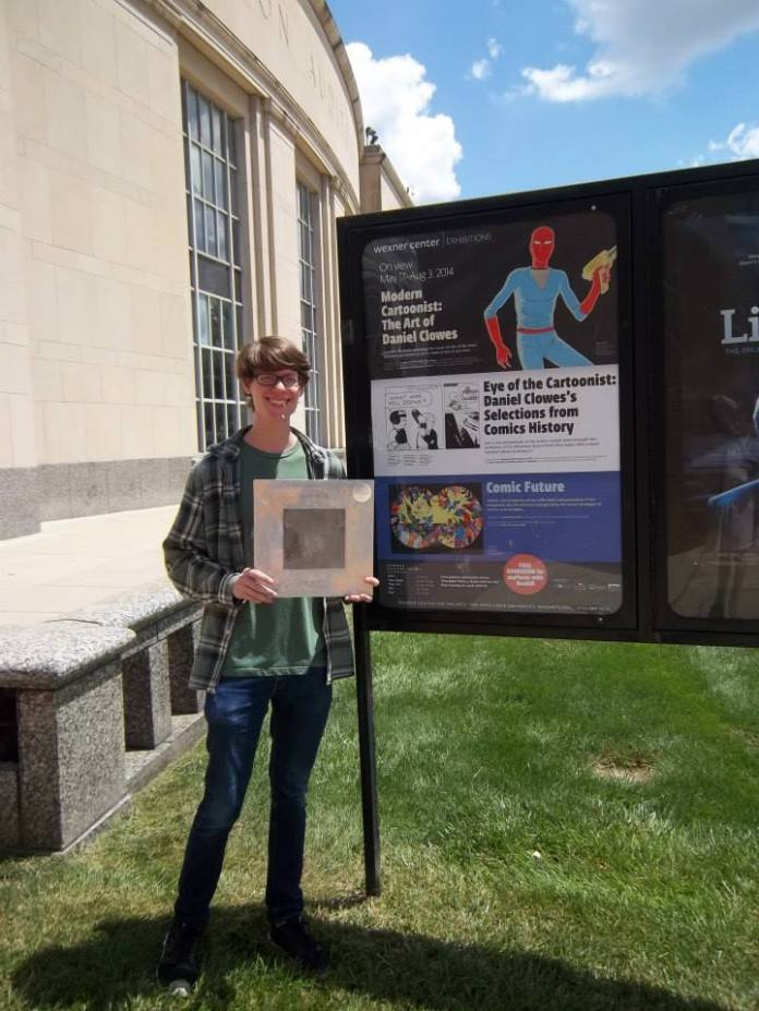 Proudly displaying his vinyl and the exhibit info sign.